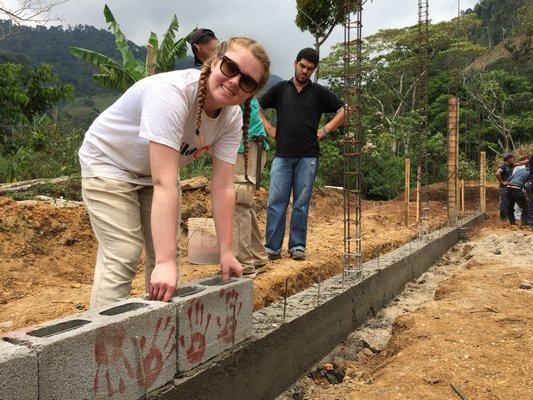Emily McGovern lays bricks for the new Nicaraguan school. COURTESY OF ANDREA HERNANDEZ