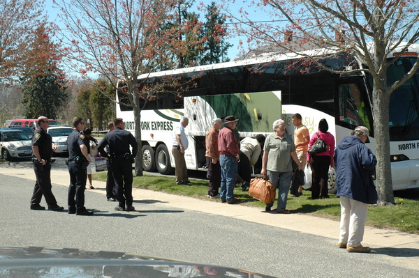 East Hampton Village Police officers wait for passengers to get off a Long Island Rail Road shuttle bus on Thursday after receiving a report of a fight among passengers. STEPHEN A. KOTZ