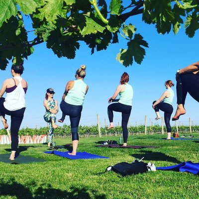 An outdoor yoga class at the Wolffer Estate Vineyard in Sagaponack led by Charity Joy Robinson. COURTESY CHARITY JOY ROBINSON