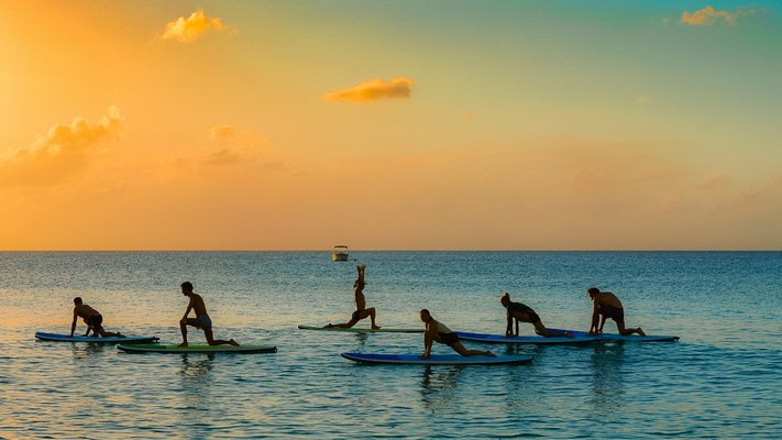 Charity Joy Robinson leading a group in paddle board yoga. COURTESY CHARITY JOY ROBINSON