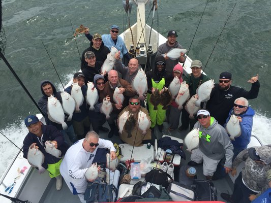 Happy anglers aboard the Hampton Lady display their haul of fluke from the Peconics after a recent trip.  Capt. Jim Foley Capt. Jim Foley