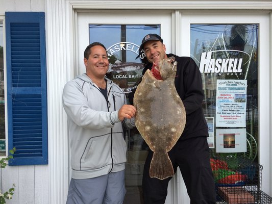 Adrian Moeller and Michael Meehan with a 10.3 pound fluke they caught in Shinnecock Inlet. Haskell's Bait & Tackle