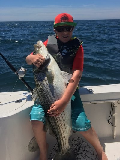 Capt. Harry Garrecht of the Montauk charter boat Breakwater shows of a big fluke caught by a young customer recently.