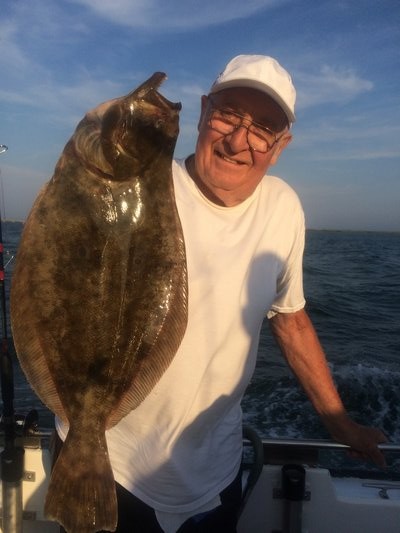 The Southampton Town Seniors program took its annual fishing trip out of Shinnecock Bay last week. Elwood Dayton of Westhampton decked this big fluke. Deena Lippman/Shinnecock Star