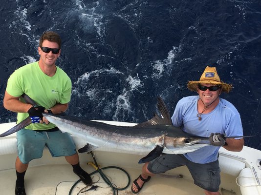 Jim Otto and Mike Briley display a nice white marlin (or is it a hatchet marlin?) they landed recently on an offshore trip. Mike Ferrara