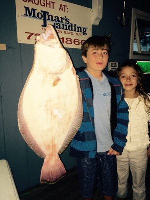 Kael and Kirra Schoerlin with their family's first entry to the Big Willy Wall at Molnar's Landing