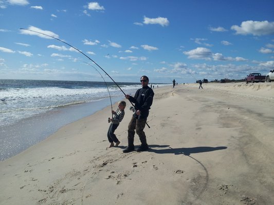 Shawn and Travis Deuel doing a little father-son job on striped bass on the beach in Southampton over the weekend. Kerri Deuel