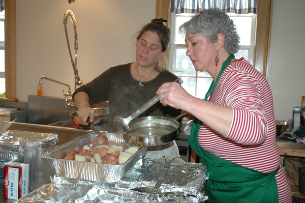 Eve Shaternik and Lisa Zaharek serve corned beef and cabbage dinners at the Springs Community Presbyterian Church on St. Patrick's Day.