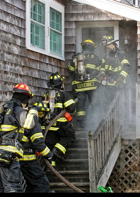 The Westhampton Beach hose team prepares to enter a soon to be demolished building in Quogue during a joint drill between the Westhampton Beach and Quogue fire departments. COURTESY WESTHAMPTON BEACH FIRE DEPARTMENT