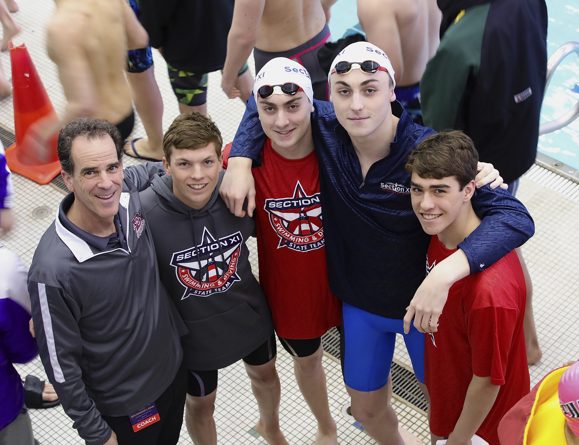 Banner Season Ends On High Note 
March 7 -- The East Hampton/Pierson/Bridgehampton boys swimming team had its best season in 2018-2019, going undefeated to win the League II title, winning the League II Championship meet, placing second in the county meet and sending six to the state meet, all program firsts. East Hampton boys swimming head coach Craig Brierley, far left, with Pierson's Ryan Duryea, East Hampton's Owen McCormac, Ethan McCormac and Aidan Forst.