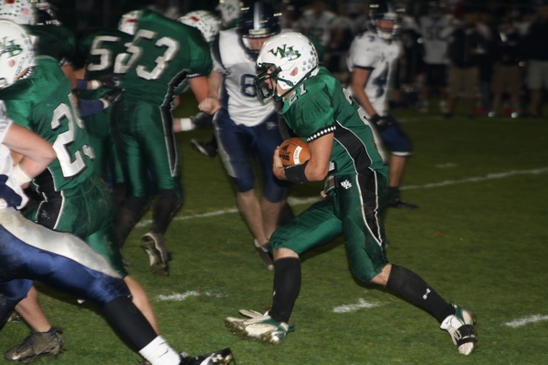 Senior halfback Vance Schindler carries the ball for the Hurricanes. 