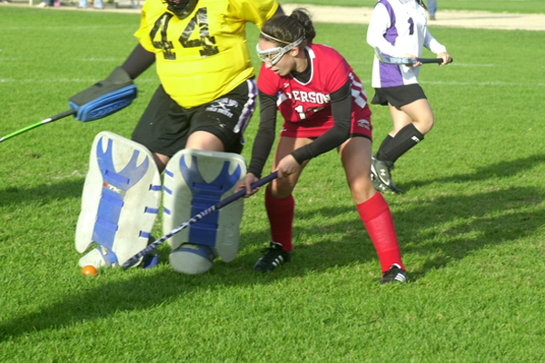 Sariah Cafiero tries to poke the ball away from Hampton Bays goalie Monica O'Connor.<br>Photo by Cailin Riley