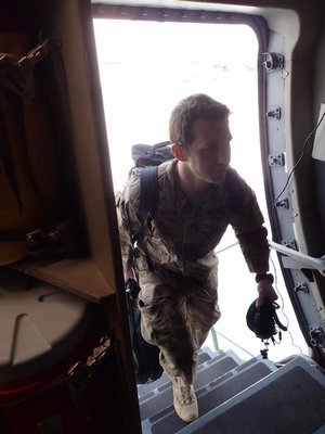 Pararescueman Staff Sergeant Ryan Dush of the New York Air National Guard's 106th Rescue Wing boards a C-17 plane bound for Hickham Airforce Base in Hawaii to participate in a joint NASA/Department of Defense mission to evaluate recovery techniques and equipment. COURTESY 106TH RESCUE WING