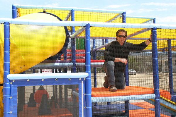 Camp Director Dave Skolnik tries out the 3- and 4-year-old playground at the Hampton Country Day Camp.