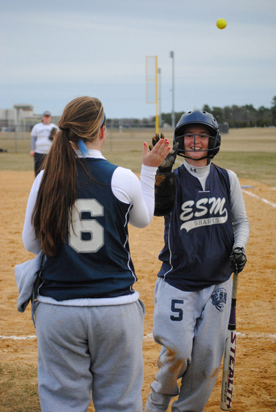 Fifth-year senior Catherine Havens gets a high-five from a teammate in the team's 9-0 win over Huntington.