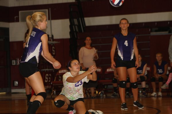 ESM's Danielle Senecal dives for a dig. BY DREW BUDD