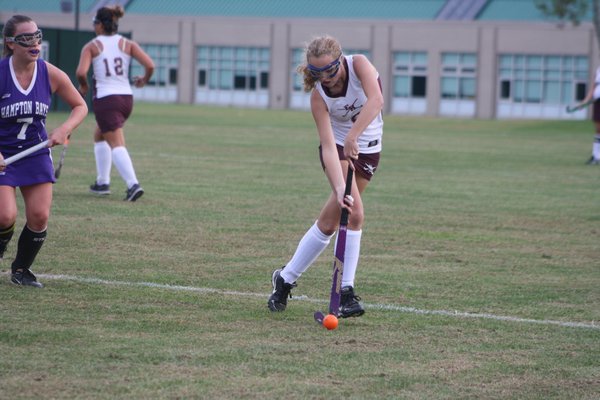 Georgia Bennett looks to bring the ball into the circle for East Hampton. CAILIN RILEY