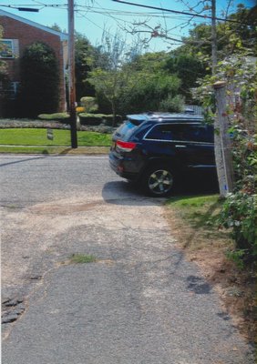 A car parked on Layton Avenue partially blocking the driveway of resident Donna Nieto. COURTESY DONNA NIETO