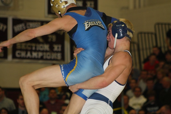 ESM's Jimmy Leach (126) has his hand raised after beating Corey Jamison of Huntington in the semifinals. Leach scored an escape and takedown in the final five seconds to win. CAILIN RILEY