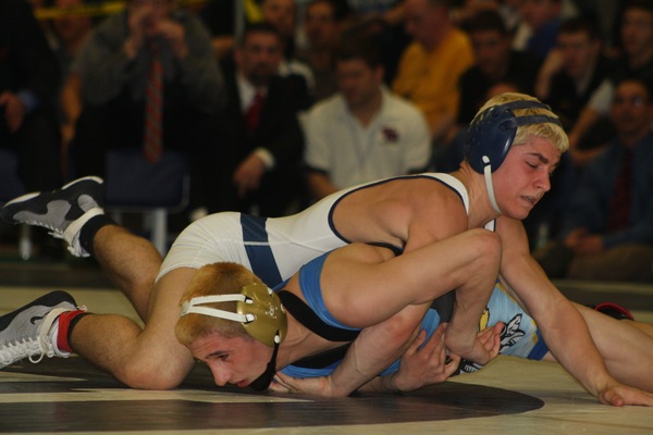 Jimmy Leach gets a hug from coach Nick Garone after beating Corey Jamison of H