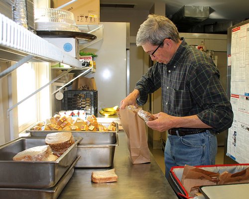 Frank Eipper packs sandwiches early Monday morning with Meals on Wheels. KYRIL BROMLEY