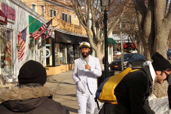 Comedy Central host Wyatt Cenac walks down Main Street in Westhampton Beach while taping a segment for The Daily Show with Jon Stewart. NEIL SALVAGGIO