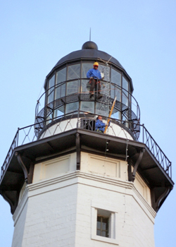 Stringing lights at the Montauk Lighthouse Monday afternoon. MICHAEL WRIGHT