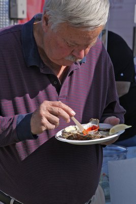  serves up some brisket and pulled pork at the Kiwanis of Greater Westhampton's 3rd annual Oyster Festival on Sunday