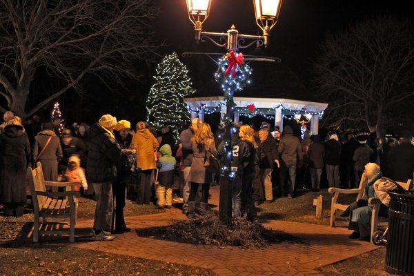 Rabbi Ari Korenblit says a few words to the crowd gathered on the Westhampton Beach village green for the tree lighting. NEIL SALVAGGIO