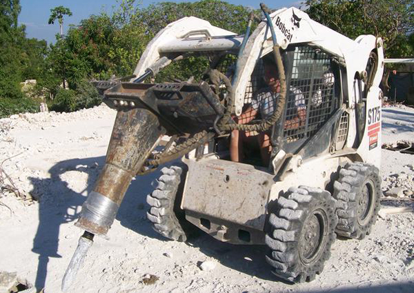 Hampton Bays resident Spencer Thorp breaks up rubble in Haiti earlier this month. COURTESY SPENCER THORP