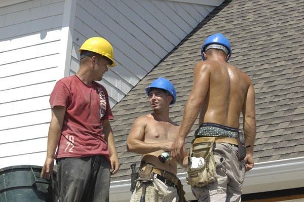 Roofers from EML Construction on the job in Southampton Village on Monday.  DANA SHAW