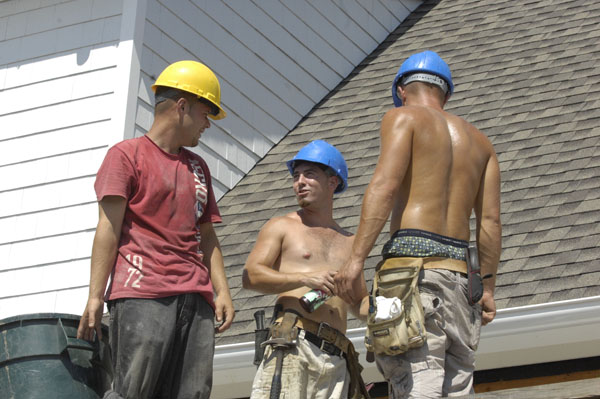 Roofers from EML Construction on the job in Southampton Village on Monday.  DANA SHAW