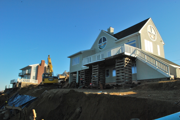 Workers scrambled to save a house on Captain Kidd's Path in Montauk in early January that was in danger of falling into Block Island Sound.                    WILL JAMES
