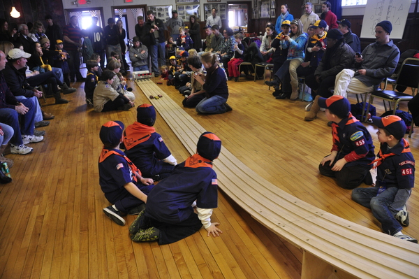 A line of wooden cars race down the track at the Sag Harbor Cub Scout Pack 445 Pinewood Derby on January 24 at American Legion Post 338 on Bay Street. MICHELLE TRAURING