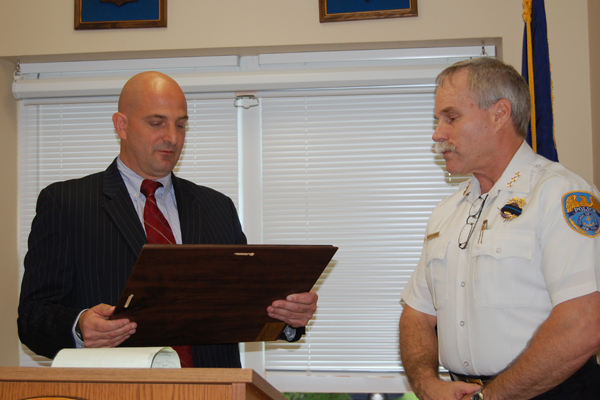  presents Quogue Village Police Chief Robert Coughlan with a plaque certifying that the department is now an accredited agency.<br>Photos by Vera Chinese