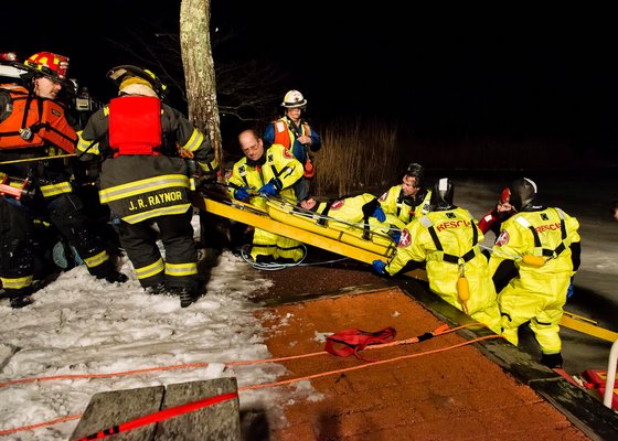 Volunteers with the Westhampton Beach Fire Department participated in an ice rescue drill on the Brook Road duck pond on the evening of Tuesday