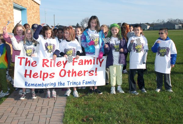 Riley Avenue School students wear special t-shirts and carried the banner at the front of the recent Trinca Family Walk-A-Thon.
