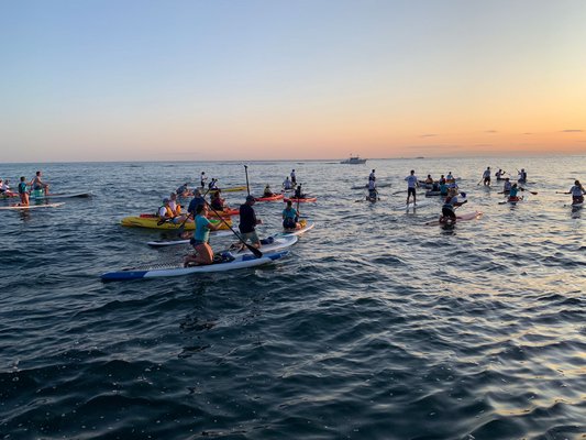 Hundreds of people attended a paddle out in memorium of Jason Pollak on Sunday evening. BY SARA LUCKEY