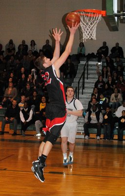 Whalers star Robbie Evjen lays the ball in for an easy two