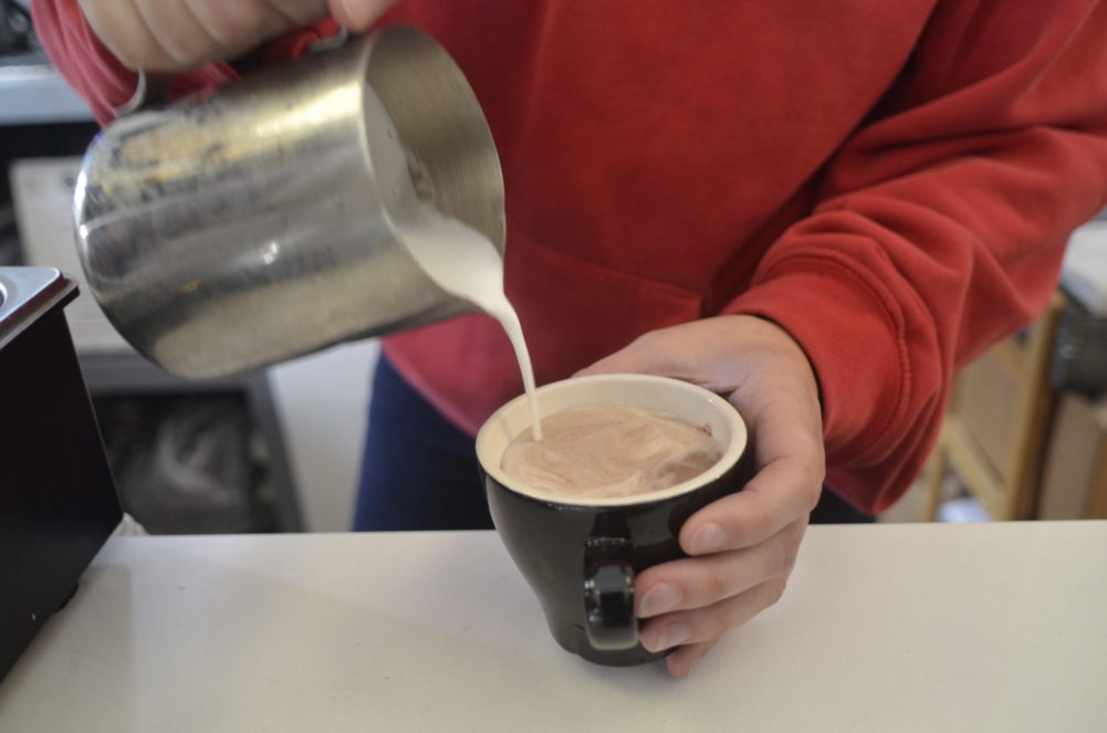 Pouring milk into hot chocolate. KIM COVELL