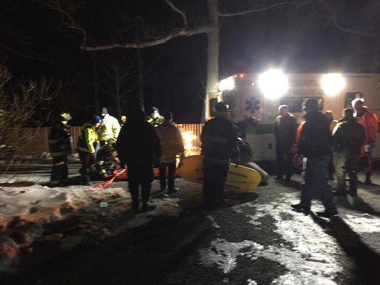 Emergency personnel on scene where two men and a dog were rescued from Moriches Bay on Monday night. COURTESY EASTPORT FIRE DEPARTMENT