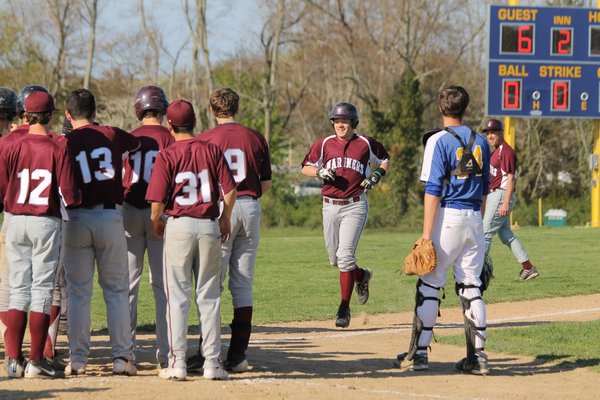 Southampton's bench comes out to congratulate Kevin Edgar after hitting a grand slam against Mattituck in the season's final game. By BRIAN NAUGHTON