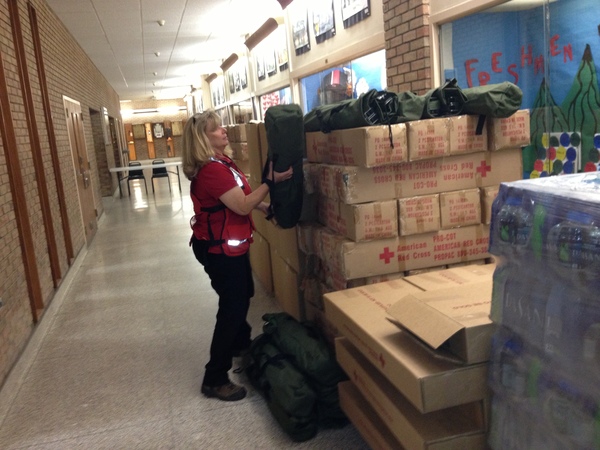 Red Cross Shelter Manager Sherry Wheaton with some of the cots at the Red Cross Emergency Shelter at Hampton Bays High School on Sunday morning. DANA SHAW