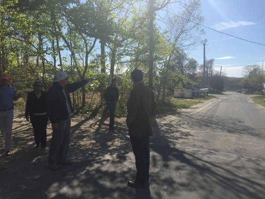 Wainscott residents gather around a map at the site of a proposed car wash during a walking tour of the business district on Friday with professional planner Peter Flinker of Dodson & Flinker. The tour was part of the town’s ongoing hamlet studies. KYRIL BROMLEY