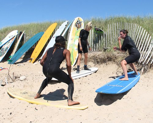 An instructor teaches a client how to surf at Ditch Plains Beach on Tuesday. KYRIL BROMLEY
