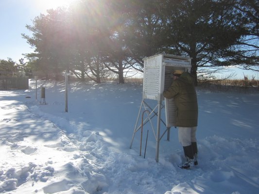 Richard Hendrickson takes a weather observation at his home in Bridgehampton. Photo courtesy of NOAA.