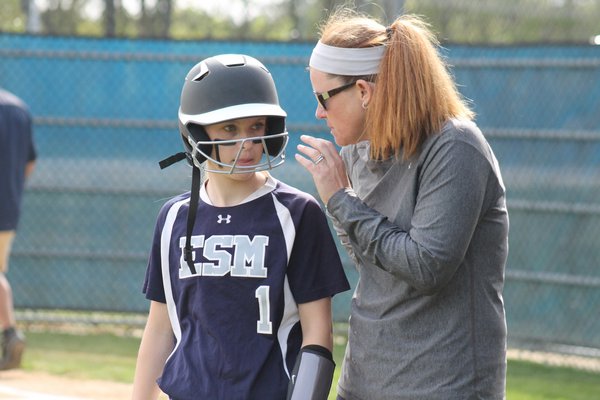 Christina Rizzi talks strategy with ESM Coach Laura Ward prior to an at bat against East Islip. KERRY MONACO