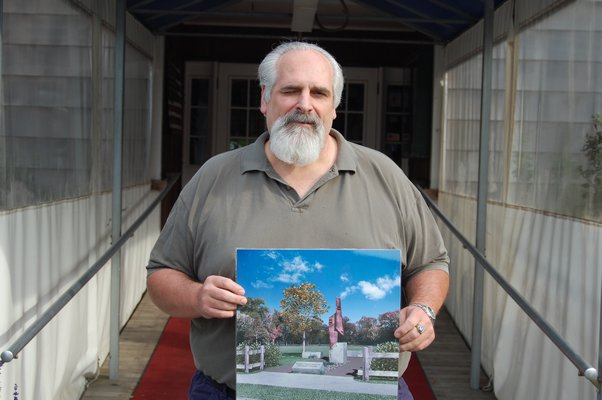 Tony Ganga with a rendering of the proposed September 11th Memorial to be built next to the American Legion Post 419 in Amagansett. JON WINKLER