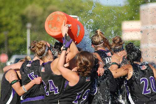 Genna Kovar and Marissa Raimo douse the team with some water after their 5-4 victory.