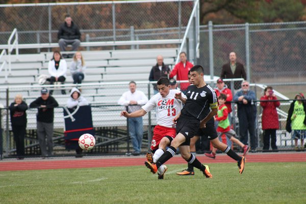 The Hampton Bays boys soccer team battles with Center Moriches in the Class B semifinals. Center Moriches won to move on to the county final against Mattituck. KERRY MONACO